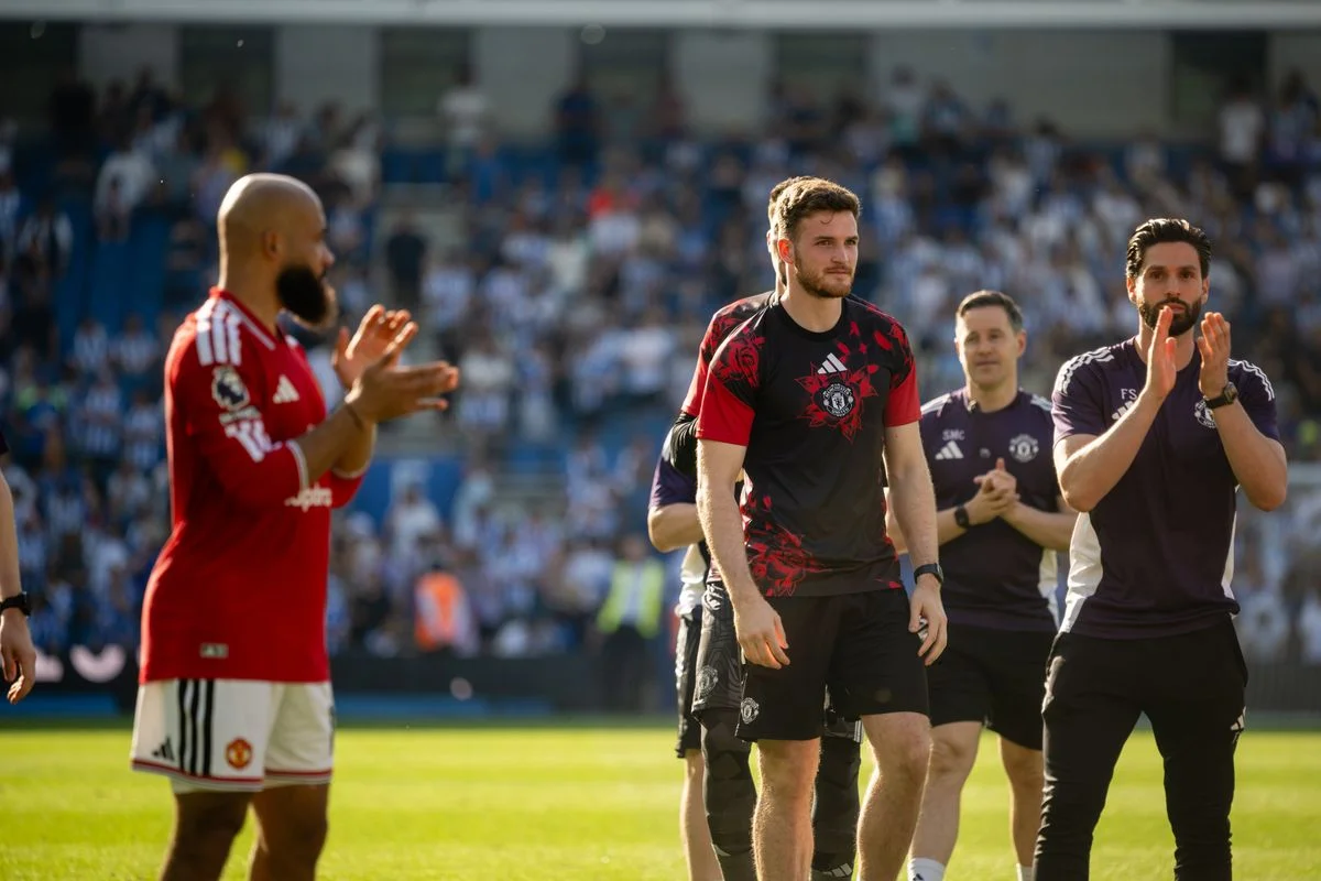 Dermot Mee pictured with the Manchester United squad following the final game of the season at Brighton