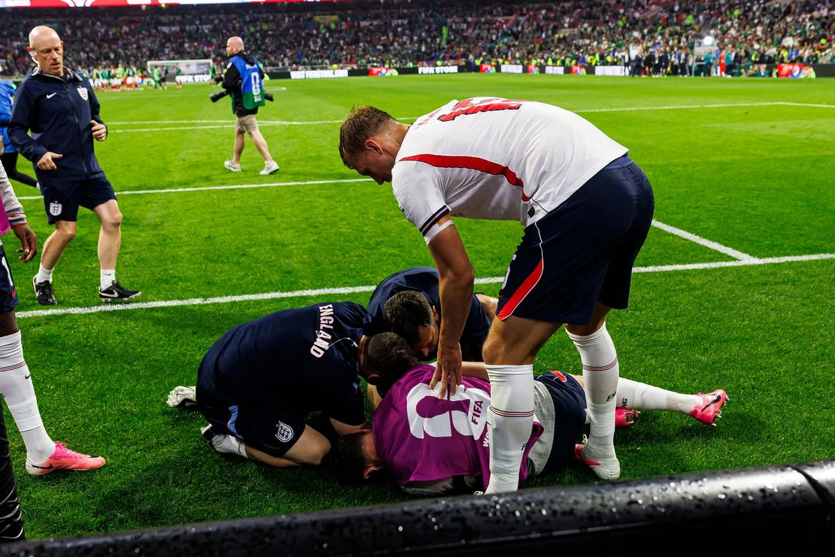 Dan Burn of England (R) tries to help his teammate Jordan Henderson who was injured amid the celebrations after winning the FIFA World Cup 2026 Round Of 16 match between Mexico and England at Mexico City Stadium on July 5, 2026 in Mexico City, Mexico.