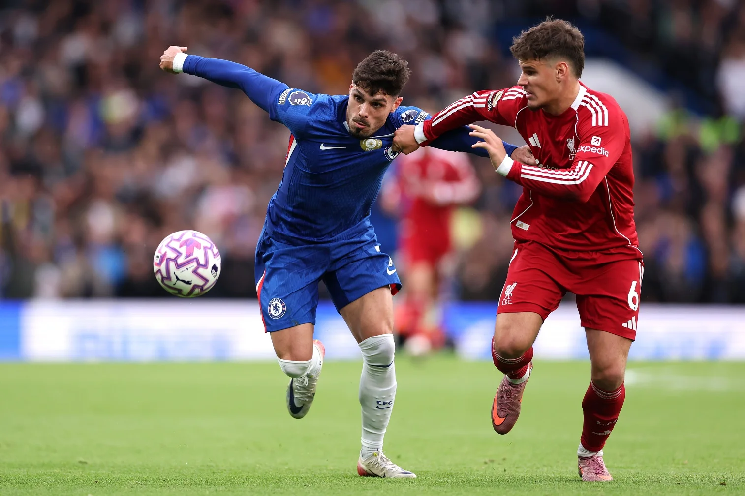 Pedro Neto of Chelsea battles for possession with Milos Kerkez of Liverpool